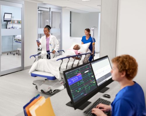 Nurse at PIC iX and physician checking mobile while patient being transport
