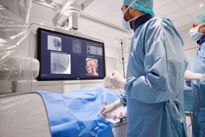 Clinicians conducting image-guided procedure with Philips Azurion system