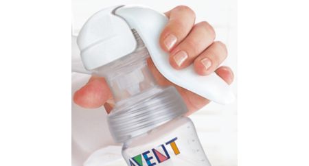 Manual breast pump with massage cushion