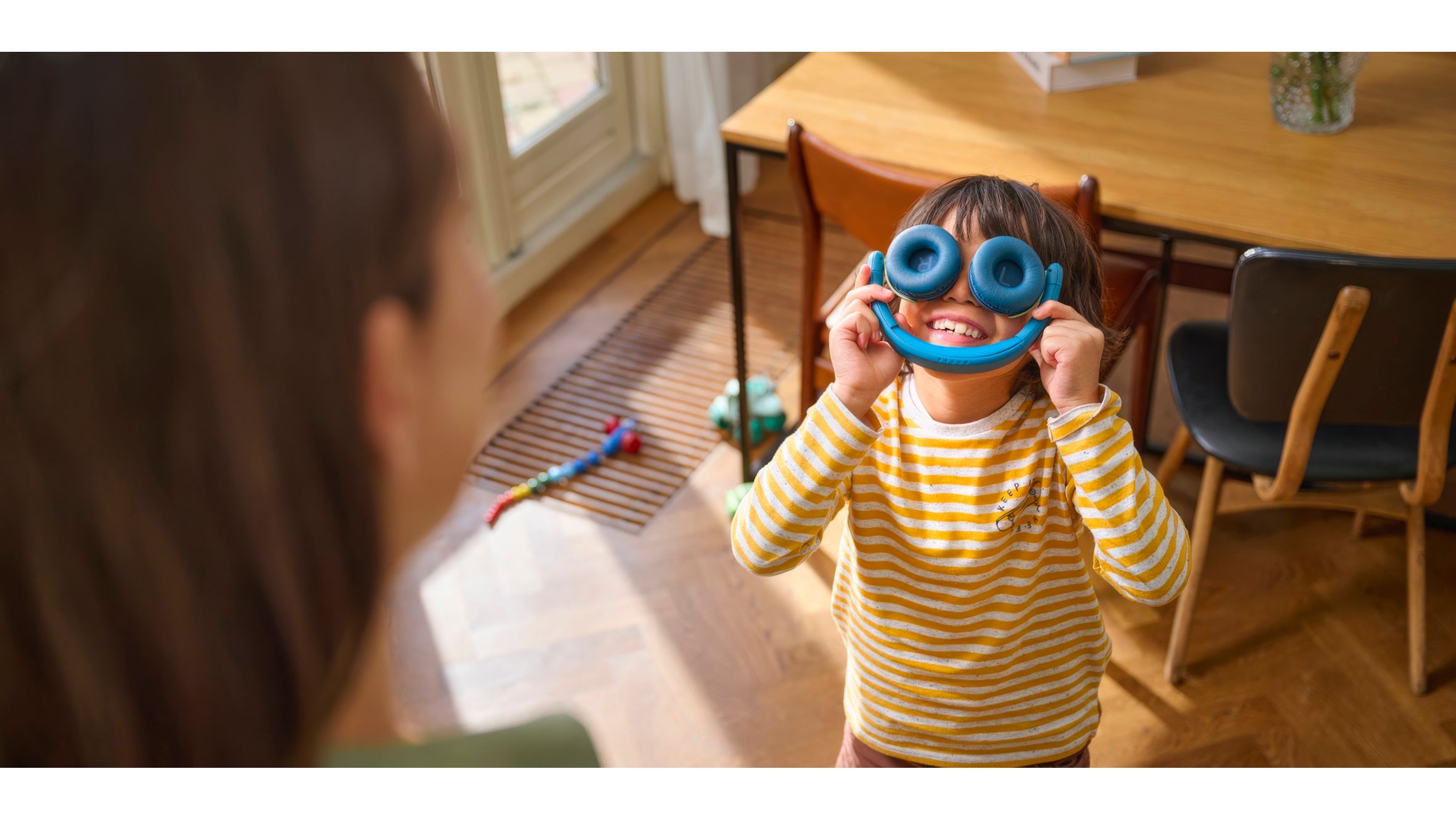 Two siblings playing while using on ear Kids Headphones