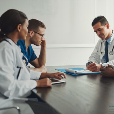 Three clinicians sitting at a table 