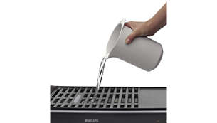 Water tray prevents food particles and grease from burning