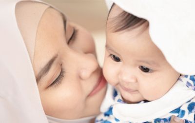 Mother bonding with baby in close embrace