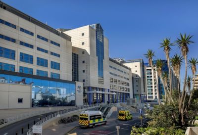 Exterior view of Gibraltar Health Authority’s St Bernard’s Hospital with ambulances outside