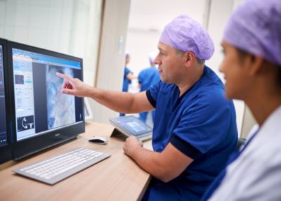 Clinicians reviewing patient imaging data using Philips IntelliSpace workstation