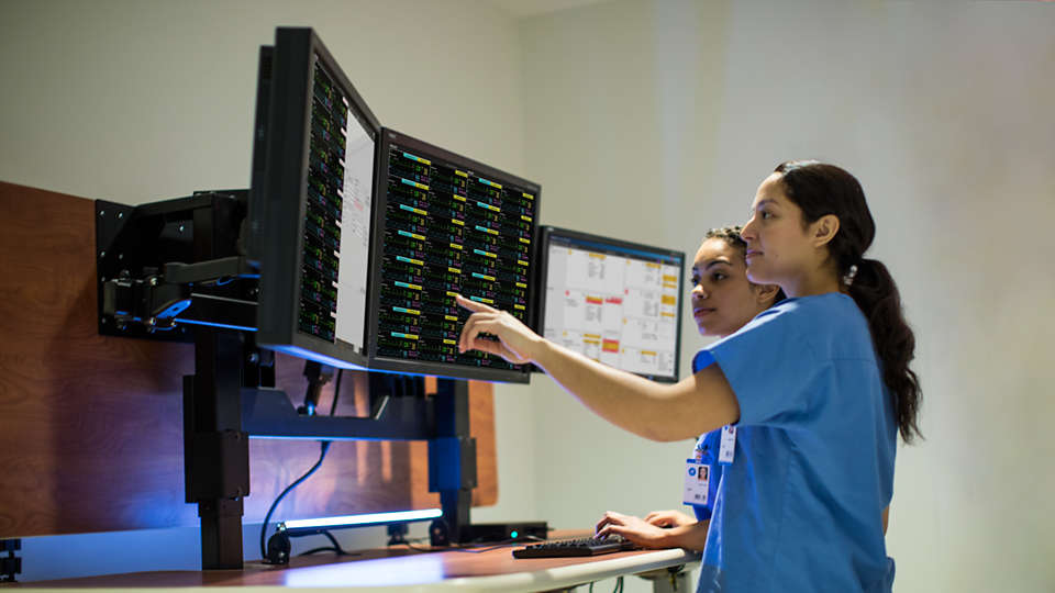 Nurses looking at a computer screen