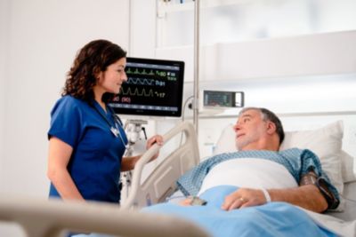 Nurse caring for male patient with MX850 and X3
