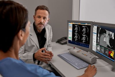 Clinician reviewing CT imaging data on workstation for diagnostic analysis