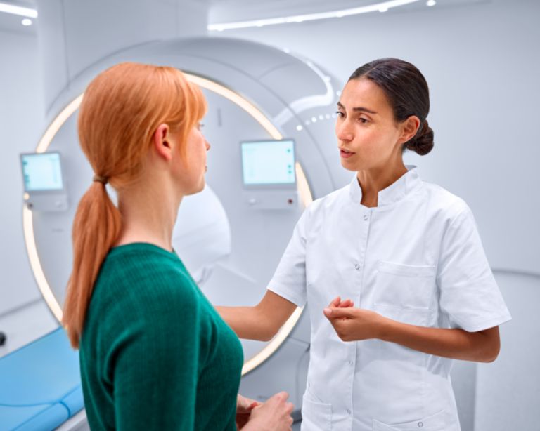 technologist comforting patient in the MR scanner room 