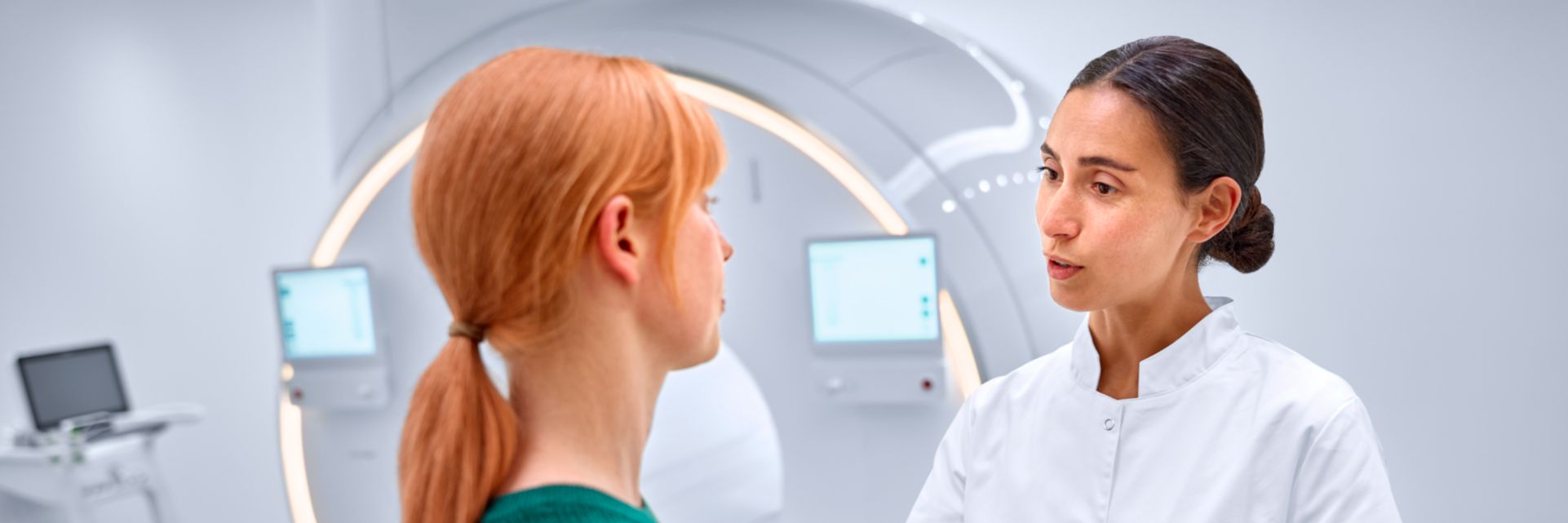 technologist comforting patient in the MR scanner room