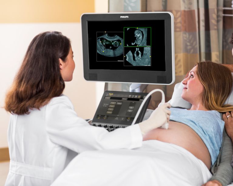 Woman receiving fetal ultrasound exam using FlexVue and Orthogonal View