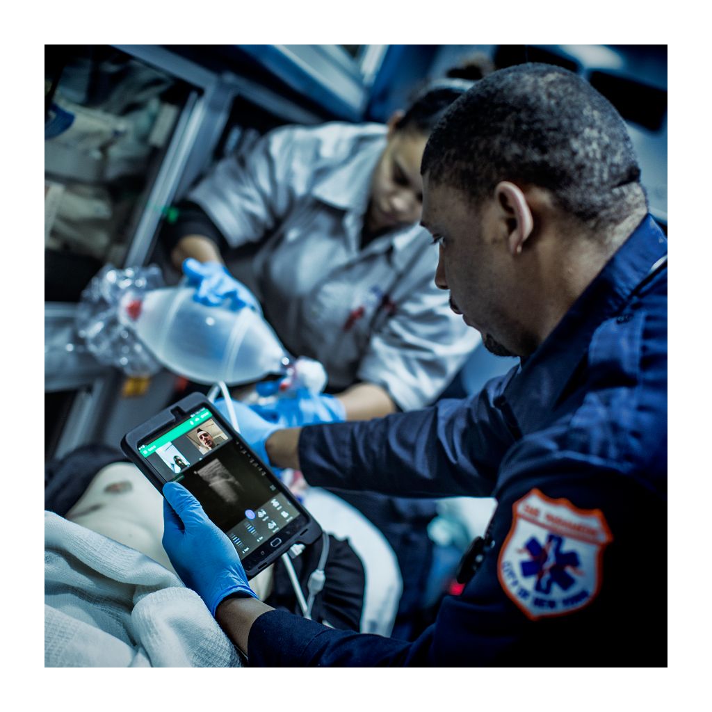 Handheld ultrasound utilizing tele-ultrasound in use in ambulance on critical patient.