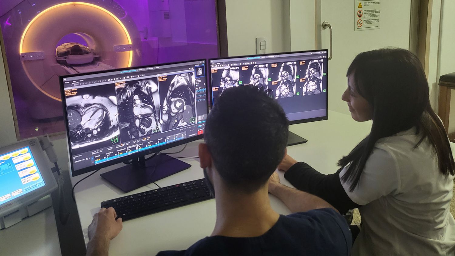 MRI technologists using dual monitor MR Workspace at FUESMEN, Argentina