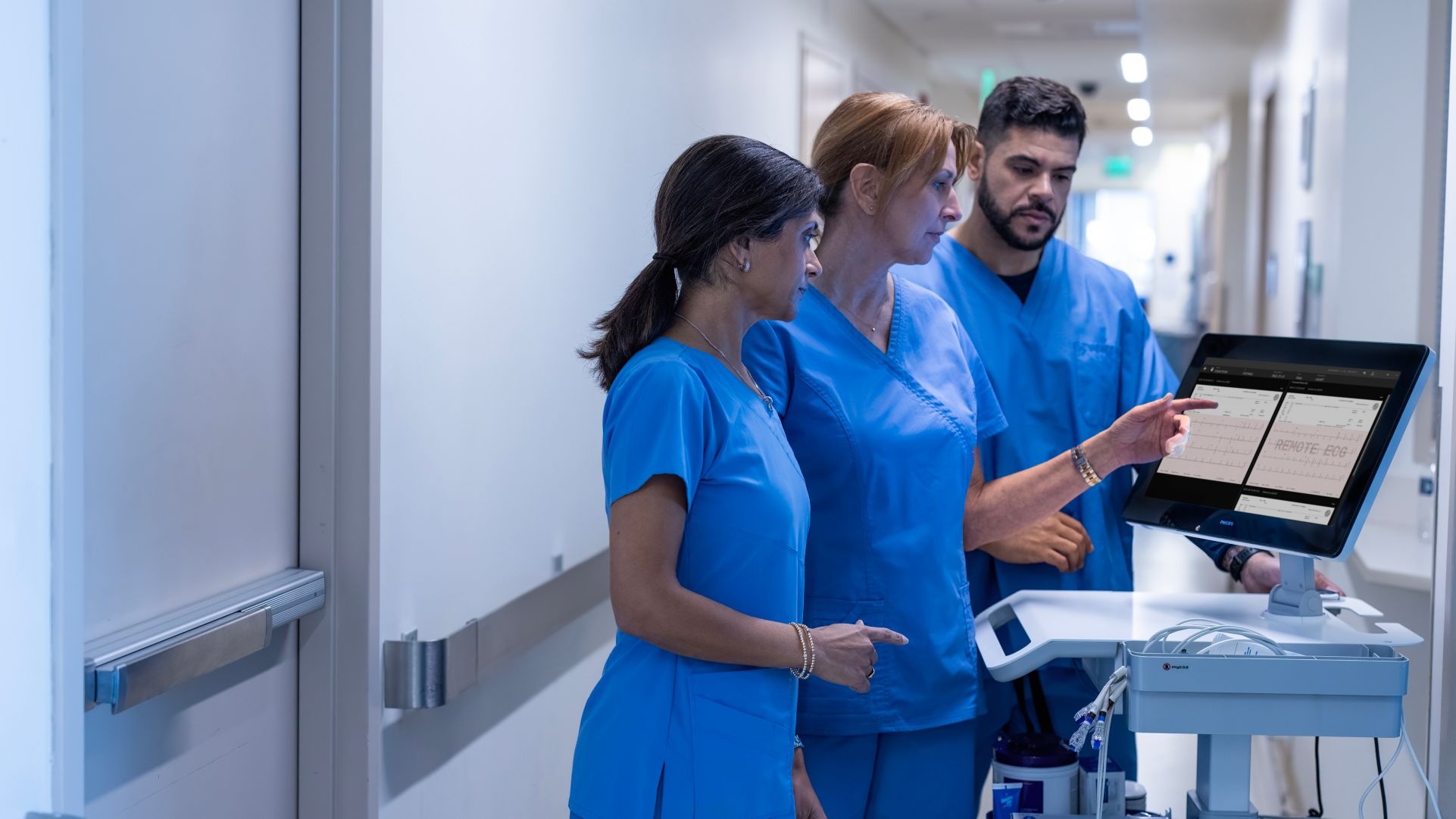 A healthcare team reviews ECG data on the high-res touchscreen available on the Cardiac Workstation.