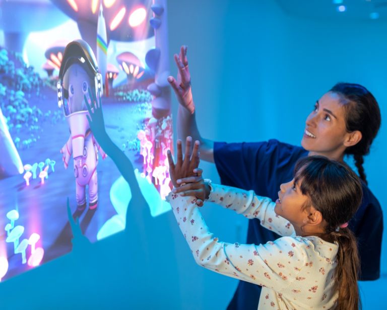 Technician putting young patient at ease 