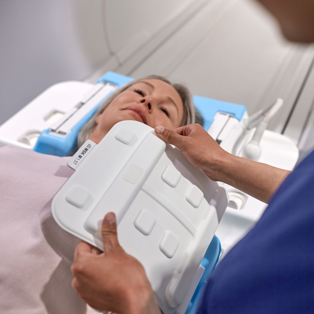 technologist positioning a flex coil on the patient