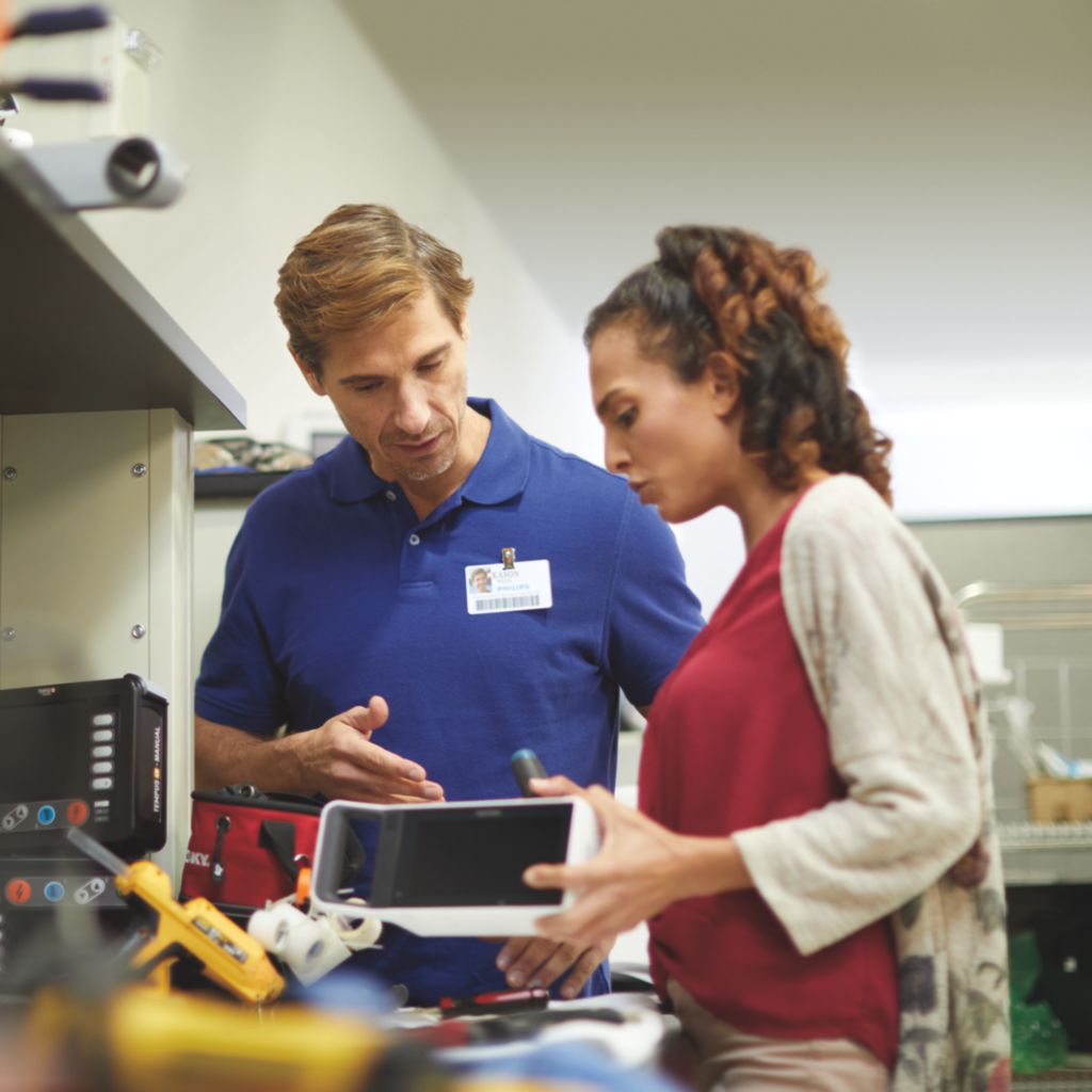 Biomed and Philips representative with X3 at bench