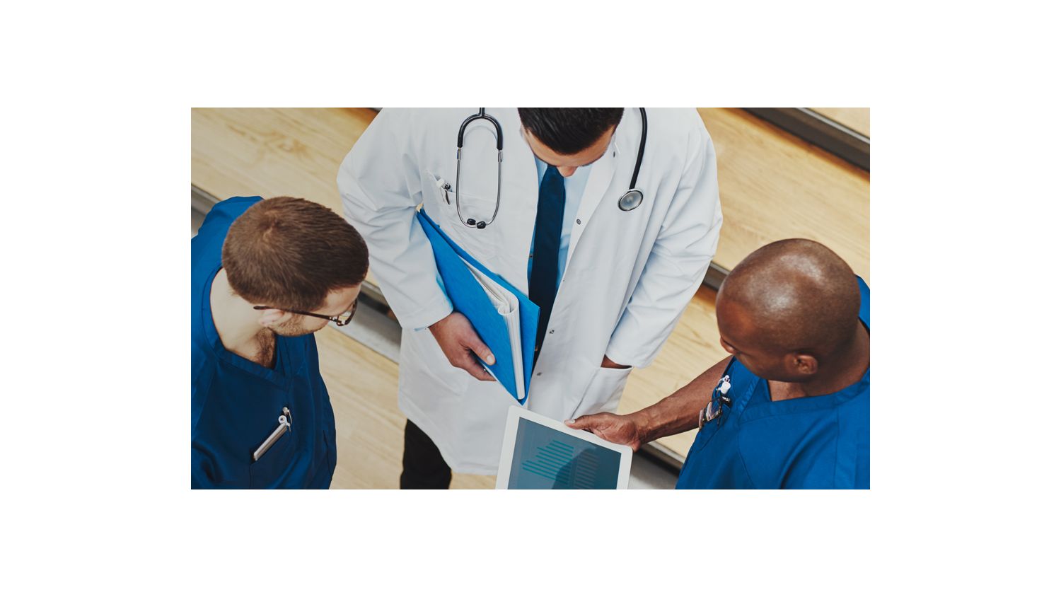 Doctors and nurses look at a tablet