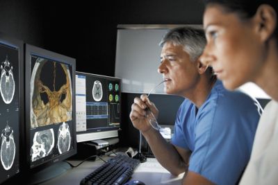 Clinicians reviewing scans from Philips Vereos Digital PET CT imaging system
