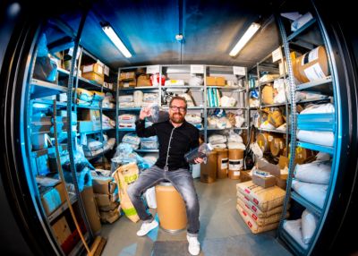 Mark Olof Dirksen sitting in storage room with recycled plastic materials