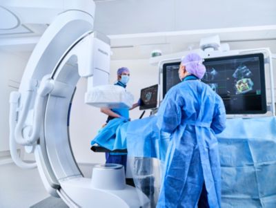 Clinical team performing image guided therapy procedure using advanced imaging system in operating room