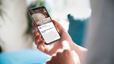Person viewing March of Dimes NICU content in Philips Avent Pregnancy plus app on smartphone