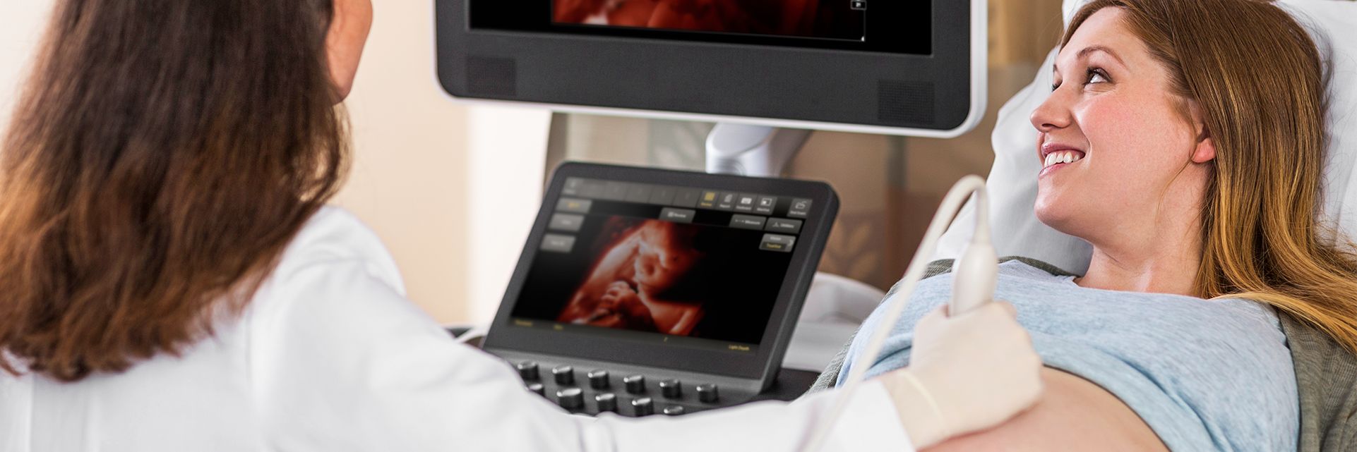 Woman receiving OB ultrasound scan using TrueVue with TouchVue