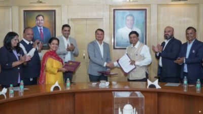University and Philips representatives exchanging signed mou documents and handshake in Pune
