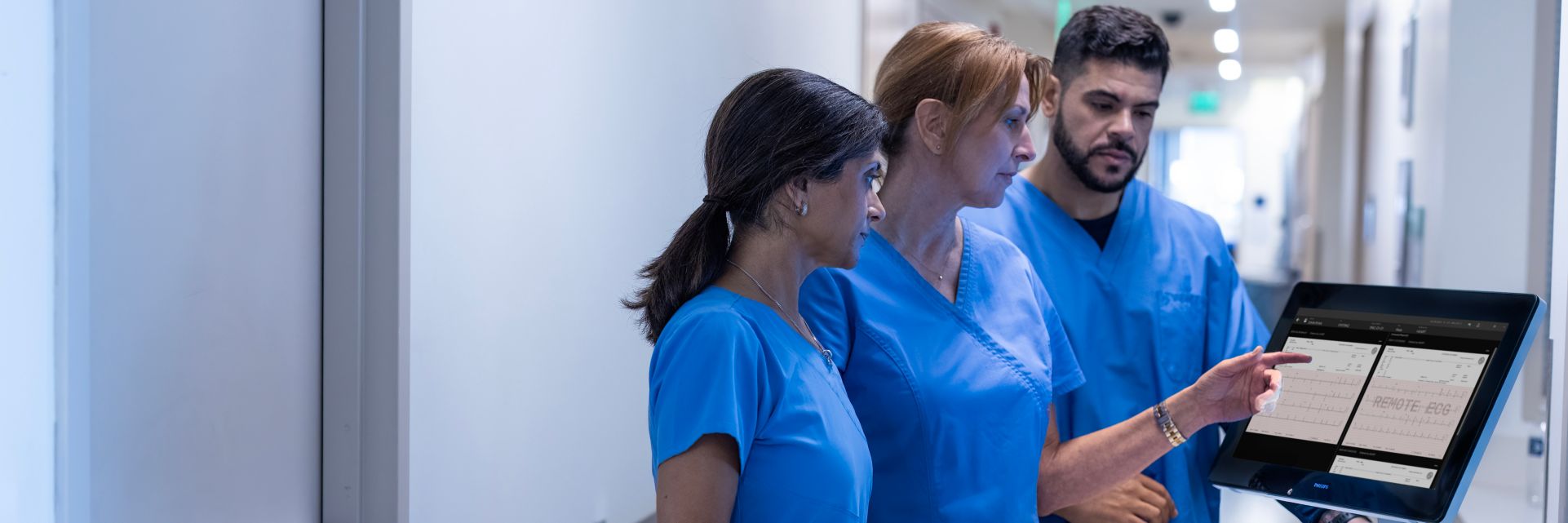 three nurses around a cardiac workstation