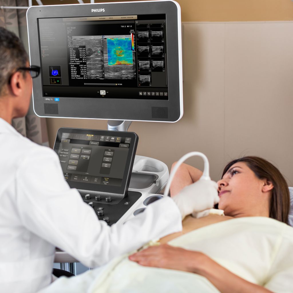 A clinician performs a breast ultrasound