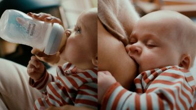 Bebis matas med flaska och ammas i mammans armar.
