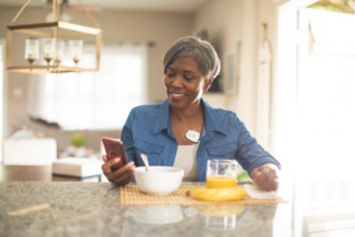 Senior Using Smartphone at Breakfast