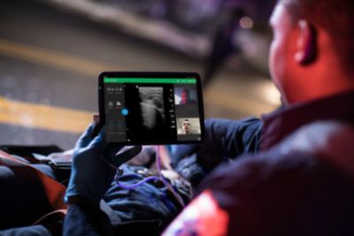 Emergency medical technician using Philips Lumify with Reacts tele ultrasound on tablet