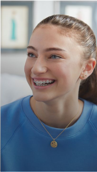 A patient with braces is smiling