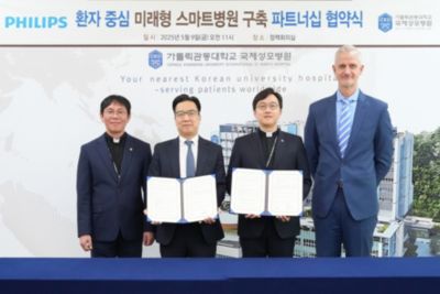Representatives from Philips Korea and International St Mary's Hospital hold signed MOU documents