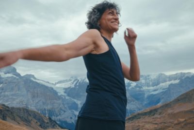 Woman running outdoors with mountain background