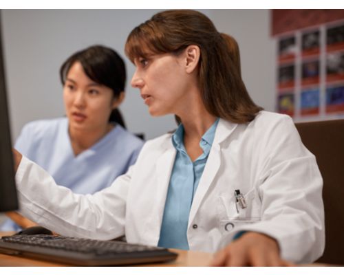 Doctors working on computer