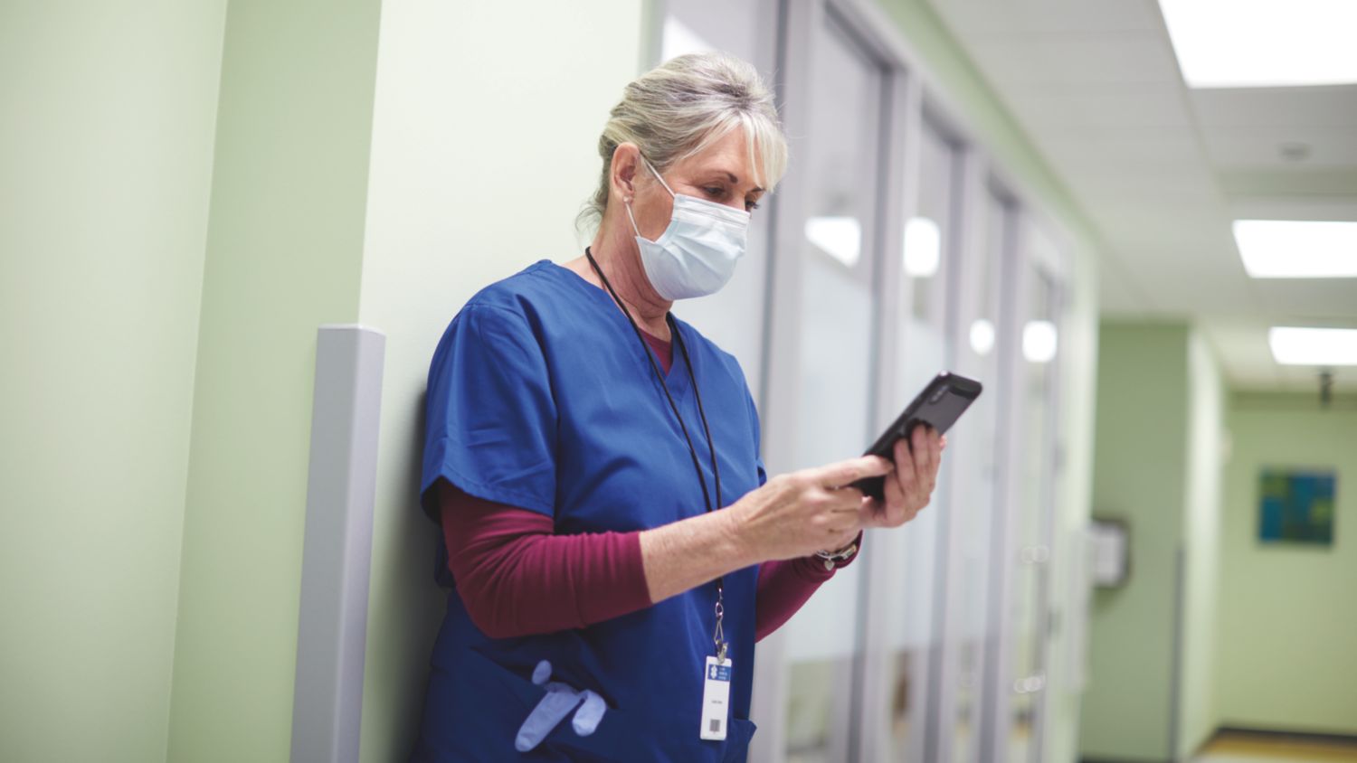 Nurse in hallway with phone