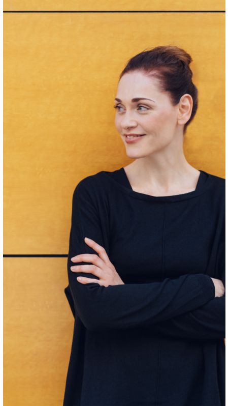 A woman smiling to the side