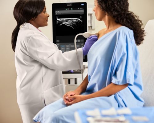 MSK clinician scanning patient shoulder with PureWave transducer.