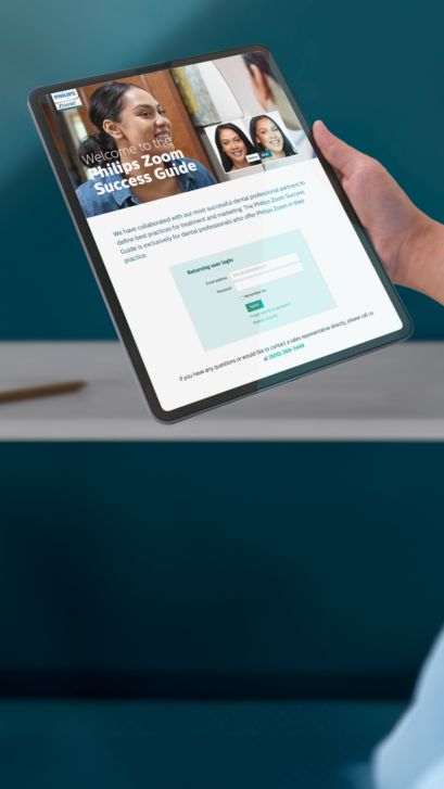 A dental professional looking at the Philips Zoom! Success Guide