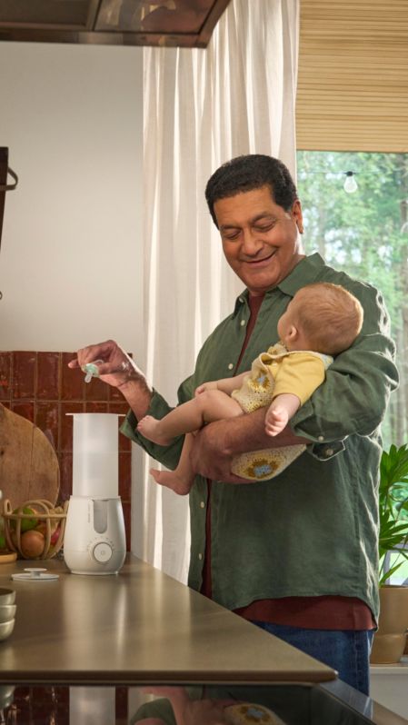 Parent using Premium 2-in-1 Warmer & Sterilizer