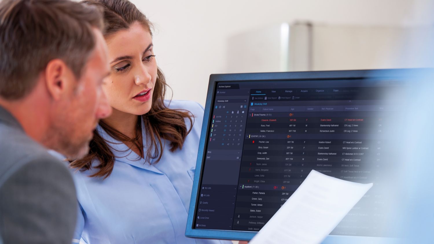 Radiologists checking patient data on a monitor