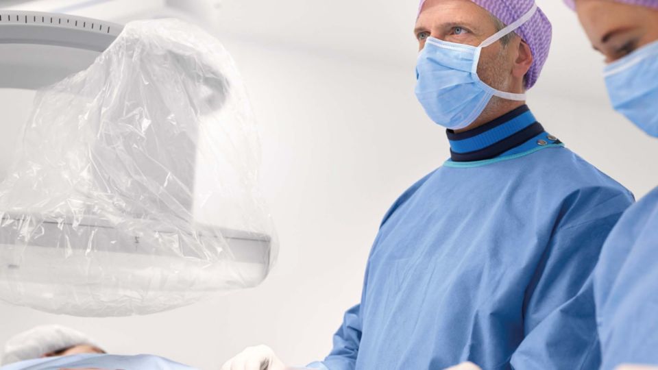 clinicians performing an interventional procedure in a cath lab