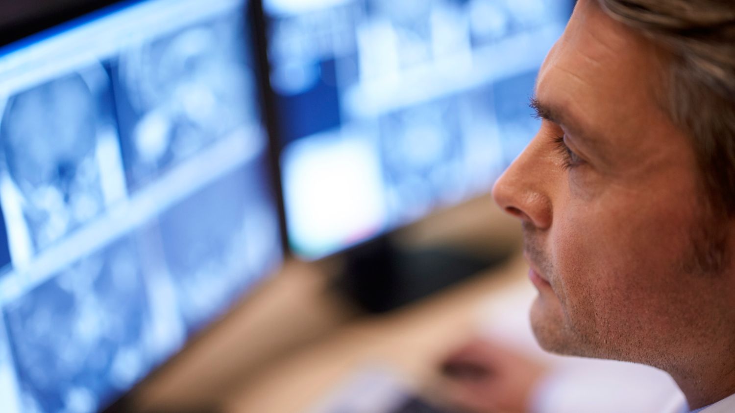 Clinician looks at radiology images on a monitor