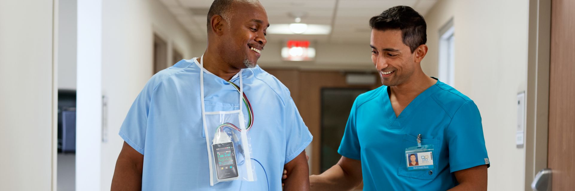 patient wearing a telemetry monitor 5500 walking with a clinician
