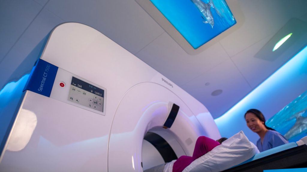Patient in CT7500 guided by a radiographer, with Ambient Experience