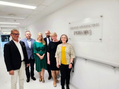 Przedstawiciele firmy Philips stoją przy znaku Centrum Referencyjnego Philipsa w Polsce