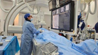 Clinician performing image guided procedure using Philips Azurion system in angiography room