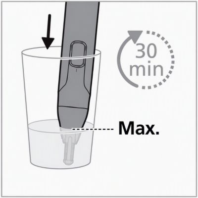 Soaking a nose trimmer's trimming head in a glass of water